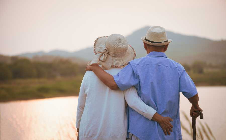 Anniversary Couple Embracing overlooking a forest scene