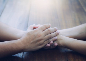 Holding hands in compassionate gesture